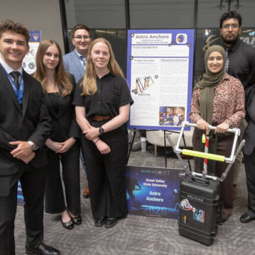 The Astro Anchors pose next to the project that earned them a trip to the Johnson Space Center